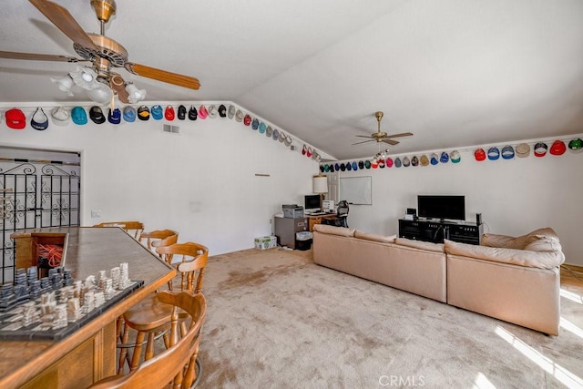 living area featuring lofted ceiling, carpet floors, visible vents, and a ceiling fan