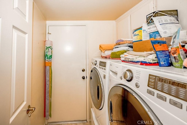 laundry room with washing machine and dryer and cabinet space