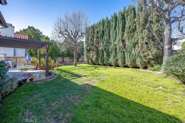 view of yard featuring a patio, a fenced backyard, and a pergola