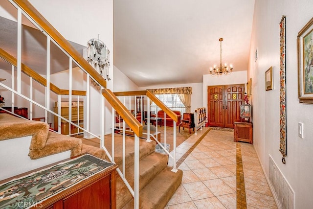 foyer entrance featuring visible vents, a notable chandelier, stairway, and light tile patterned floors