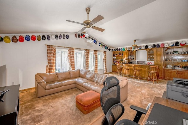 living area featuring lofted ceiling, bar area, and ceiling fan