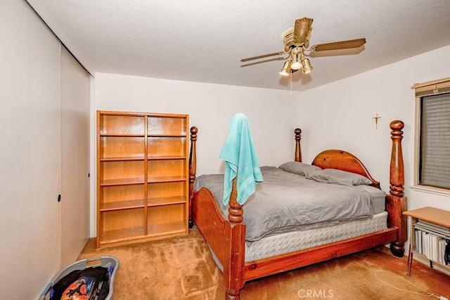 bedroom featuring a closet, light carpet, and ceiling fan