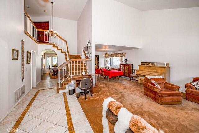 interior space with arched walkways, stairway, visible vents, and an inviting chandelier