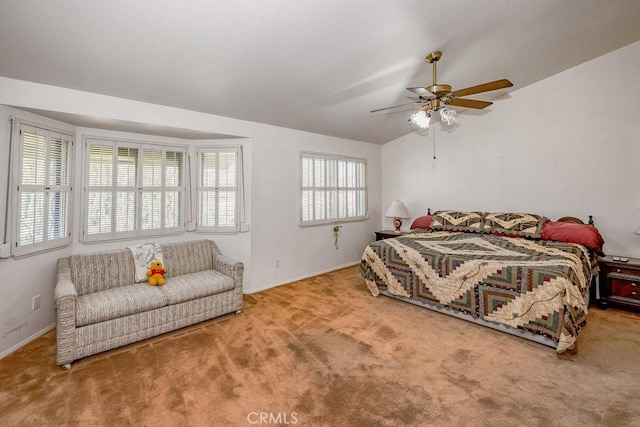 carpeted bedroom featuring a ceiling fan, vaulted ceiling, and baseboards