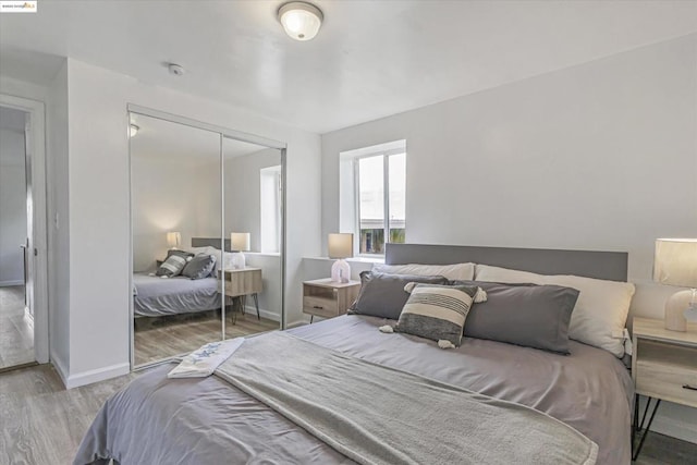 bedroom with hardwood / wood-style floors and a closet