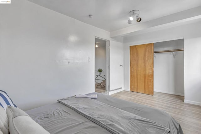 bedroom featuring light hardwood / wood-style floors and a closet