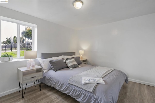 bedroom featuring dark hardwood / wood-style flooring