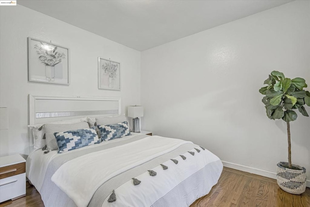 bedroom with hardwood / wood-style flooring