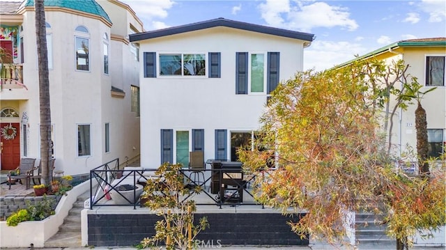 217 10th St, Seal Beach, CA 90740 - view of front of home with stucco siding and stairway