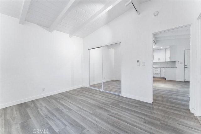 217 10th St, Seal Beach, CA 90740 - unfurnished bedroom with light wood-style flooring, a closet, baseboards, and wooden ceiling