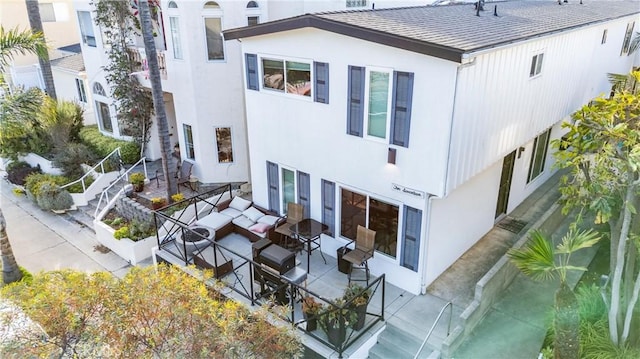 217 10th St, Seal Beach, CA 90740 - back of property featuring a patio area, an outdoor hangout area, and stucco siding