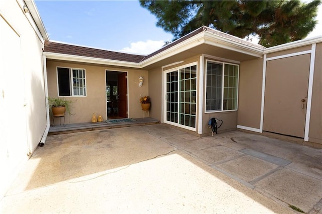 view of exterior entry featuring a patio