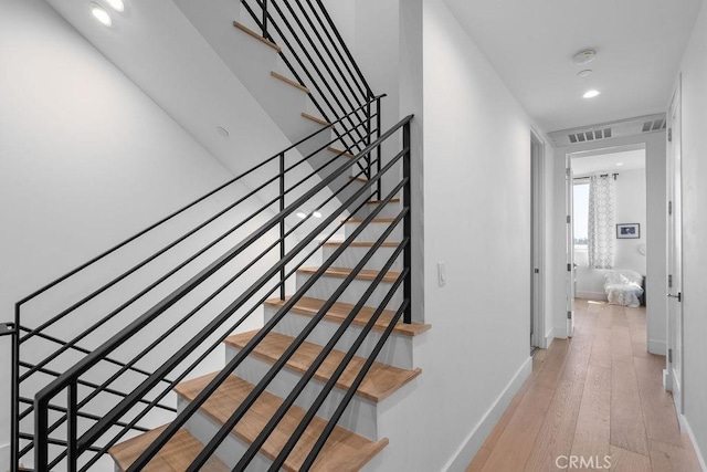 stairway with hardwood / wood-style flooring