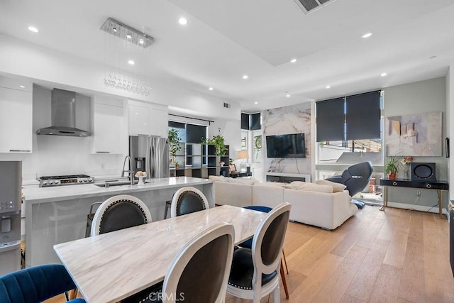 dining room featuring sink and light hardwood / wood-style floors