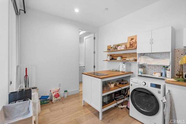 washroom with washer / clothes dryer and light wood-type flooring