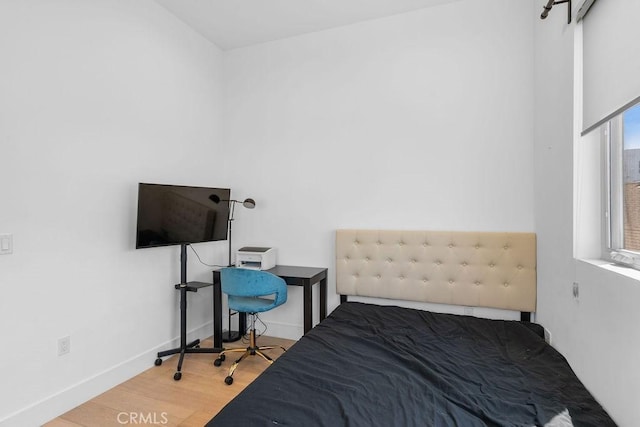 bedroom with wood-type flooring