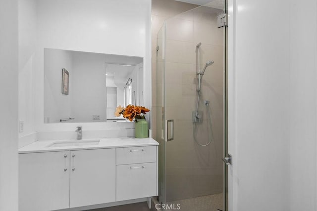 bathroom featuring vanity and an enclosed shower