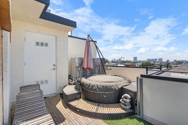 wooden terrace featuring a hot tub