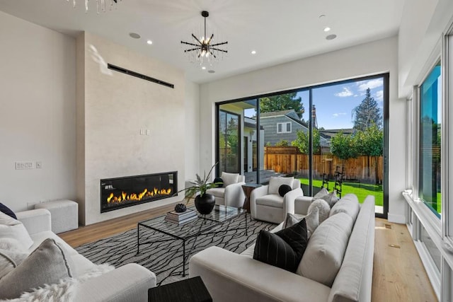 living room featuring a chandelier and light hardwood / wood-style flooring