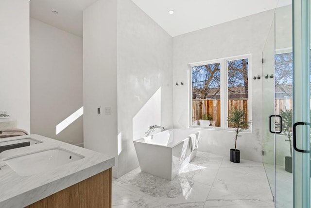 bathroom with vanity and independent shower and bath