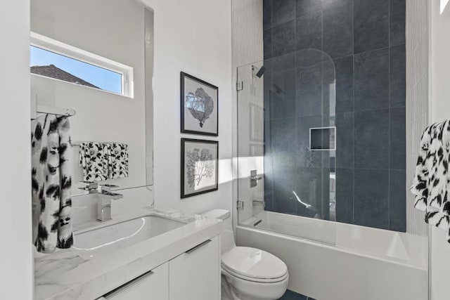 full bathroom featuring vanity, toilet, and tiled shower / bath combo