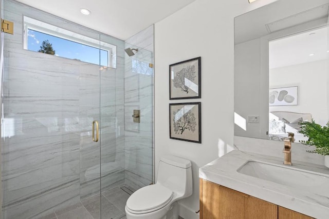 bathroom with vanity, toilet, and a shower with door