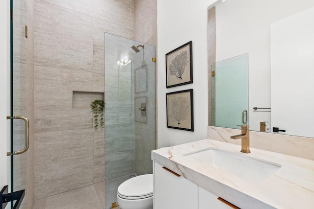 bathroom featuring walk in shower, vanity, and toilet