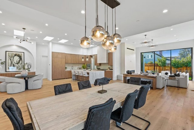 dining area featuring a notable chandelier and light hardwood / wood-style floors