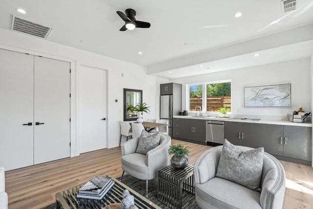 interior space featuring sink, light hardwood / wood-style flooring, and ceiling fan