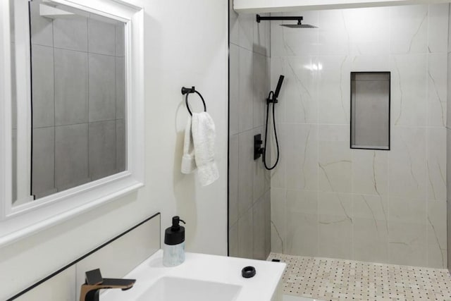 bathroom featuring sink and a tile shower