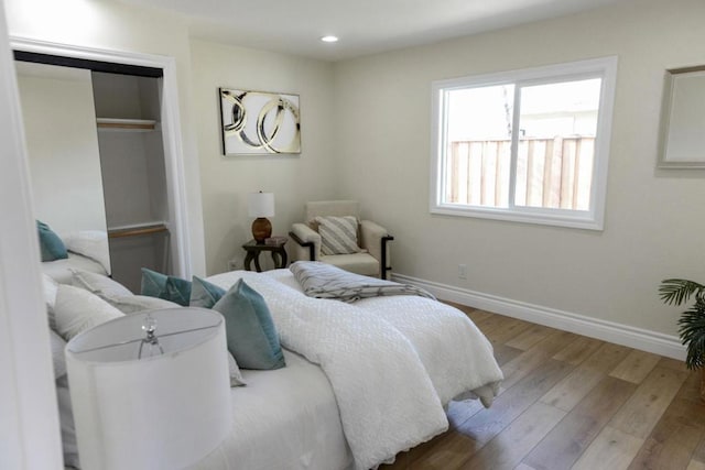 bedroom with hardwood / wood-style flooring and a closet