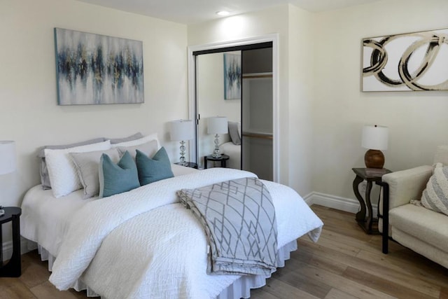 bedroom featuring a closet and light wood-type flooring