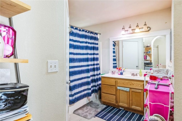 bathroom with vanity and curtained shower