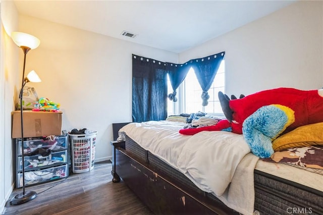 bedroom with dark wood-type flooring