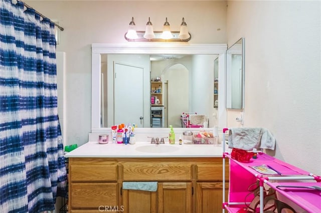 bathroom with walk in shower and vanity