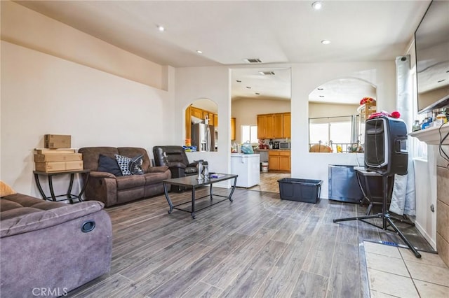 living room featuring hardwood / wood-style flooring and lofted ceiling