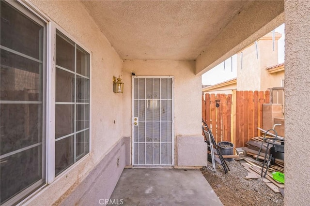 view of exterior entry with a patio