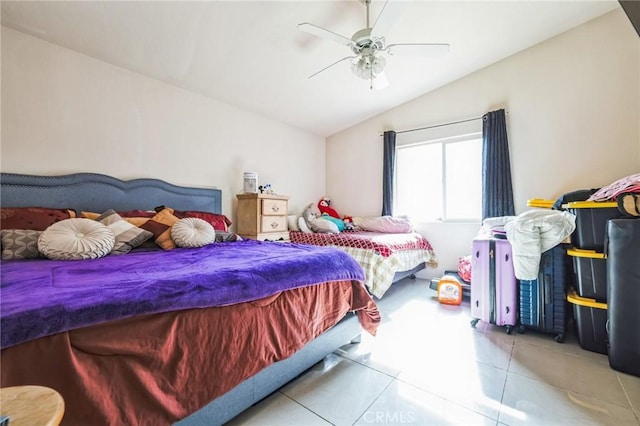 bedroom featuring light tile patterned floors, vaulted ceiling, and ceiling fan