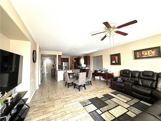 living room with ceiling fan and light hardwood / wood-style flooring