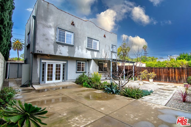 back of property featuring french doors and a patio