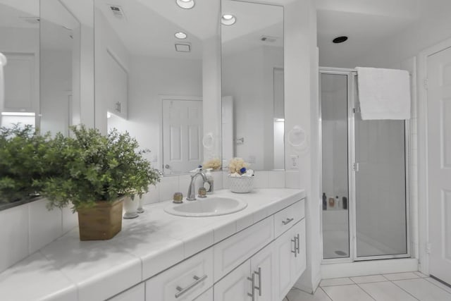 bathroom with vanity, tile patterned flooring, and walk in shower