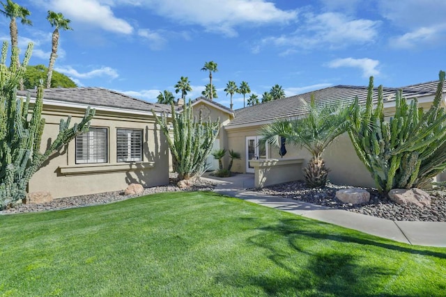 ranch-style home with a front lawn