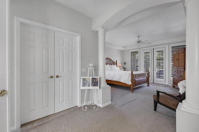 carpeted bedroom with access to exterior, a closet, ceiling fan, and ornate columns