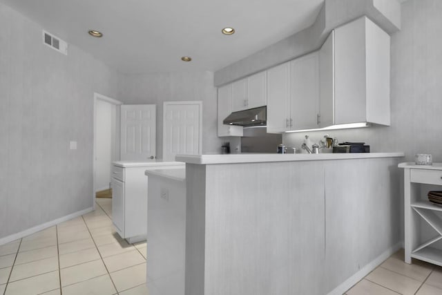 kitchen featuring white cabinetry, light tile patterned floors, and kitchen peninsula