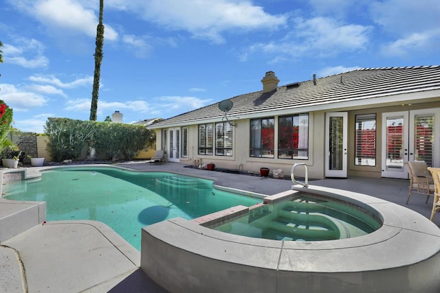 view of swimming pool with a patio and an in ground hot tub