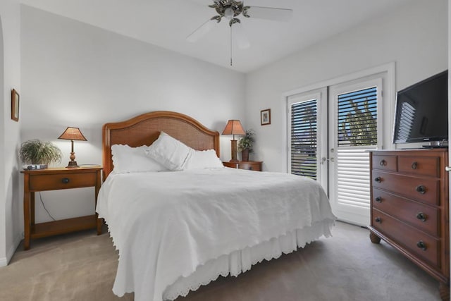 bedroom with access to outside, light colored carpet, and ceiling fan