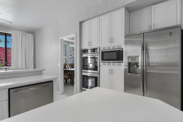 kitchen with stainless steel appliances and white cabinets