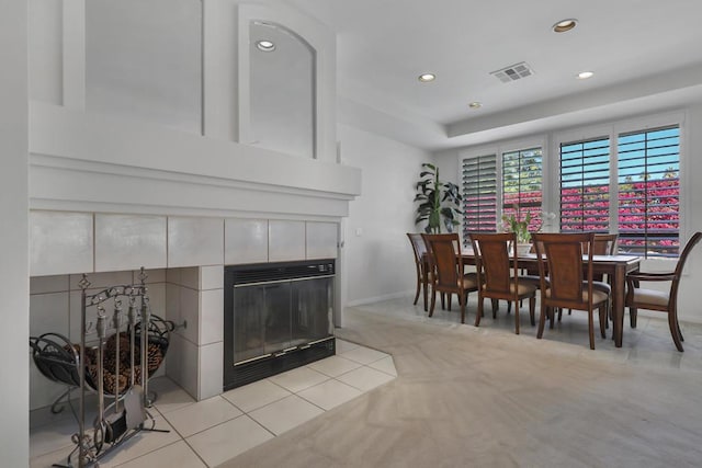 dining space featuring a tile fireplace