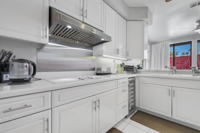 kitchen featuring light tile patterned flooring, white cabinetry, sink, wine cooler, and ceiling fan