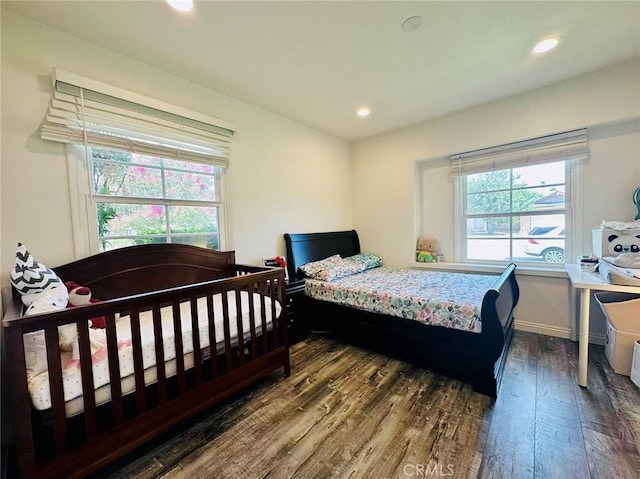 bedroom with dark hardwood / wood-style flooring